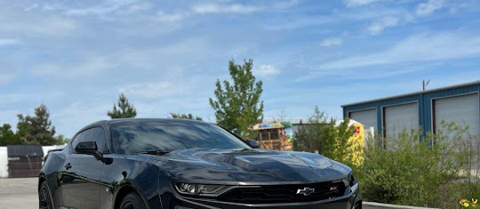 Black Chevrolet Camaro SS outside the shop