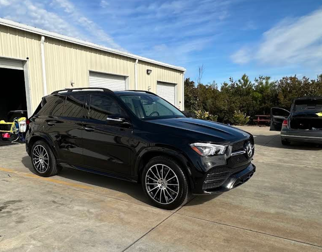 Black Mercedes GLE with tinted windows outside the Conway shop