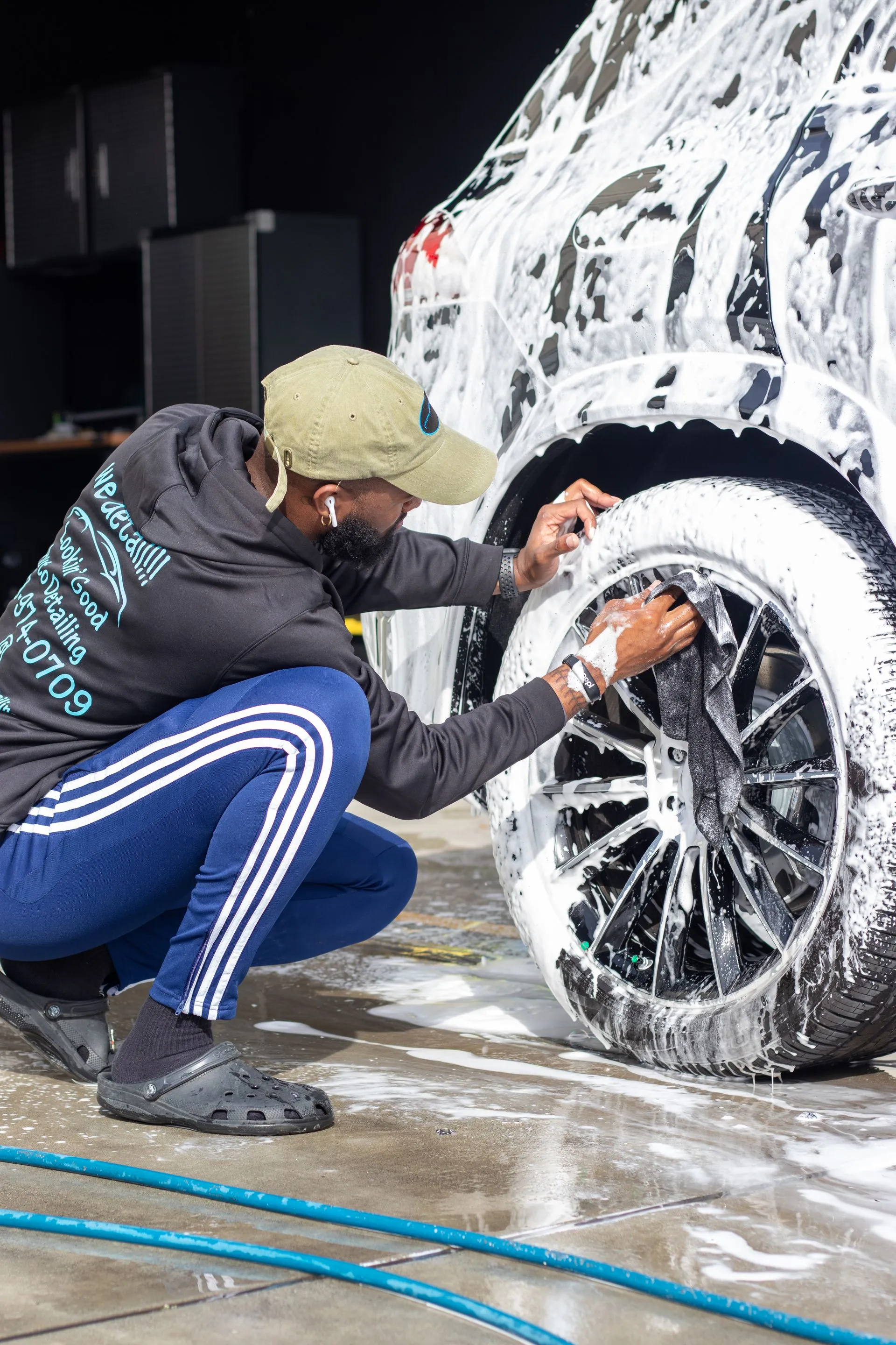 Hand cleaning a wheel during an exterior detail